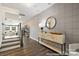 Welcoming foyer area with wood-look floors, decorative console table, modern wallpaper, and access to stairs and living area at 32562-B Millingport Rd # 7155, New London, NC 28127