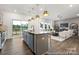 Open kitchen with a gray island, stainless steel appliances, and a view into the adjacent living room and deck at 32562-B Millingport Rd # 7155, New London, NC 28127