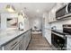 Well-lit kitchen featuring gray cabinets, stainless steel appliances, granite countertops, and wood-look floors at 32562-B Millingport Rd # 7155, New London, NC 28127
