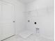 Bright laundry room with white cabinets, white shelving, and tiled floors at 32562-B Millingport Rd # 7155, New London, NC 28127