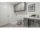 Functional laundry room with ample storage, gray cabinets, and a convenient folding area at 32562-B Millingport Rd # 7155, New London, NC 28127