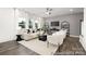 Contemporary living room with large windows, designer furniture, and decorative shelving at 32562-B Millingport Rd # 7155, New London, NC 28127