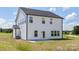 Rear view of home with light siding, black trim and walk-out door at 32616 Millingport Rd # 7144, New London, NC 28127