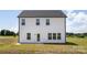 Back exterior featuring light siding, black trim and a walk-out door at 32616 Millingport Rd # 7144, New London, NC 28127