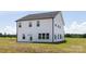 Back exterior featuring light siding, black trim and a walk-out door at 32616 Millingport Rd # 7144, New London, NC 28127