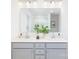 Bathroom boasts double sink vanity, chrome faucets, white countertop, and decorative greenery at 32616 Millingport Rd # 7144, New London, NC 28127