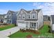 Charming two-story home with stone accents, a white garage door, landscaped yard, and craftsman architecture at 32616 Millingport Rd # 7144, New London, NC 28127
