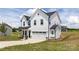 Two-story home featuring white siding, a front-facing two car garage, and a well-manicured lawn at 32616 Millingport Rd # 7144, New London, NC 28127