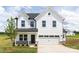 New two-story home with white siding, black door, two car garage, and manicured landscaping at 32616 Millingport Rd # 7144, New London, NC 28127