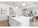 Bright open kitchen with large island, white cabinets, and stainless steel appliances for a modern look at 32616 Millingport Rd # 7144, New London, NC 28127