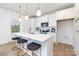 Well-lit kitchen with a large central island, white cabinetry, and modern pendant lighting fixtures at 32616 Millingport Rd # 7144, New London, NC 28127