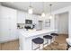 Modern kitchen featuring white cabinets, an island with seating, and stainless steel appliances at 32616 Millingport Rd # 7144, New London, NC 28127