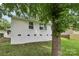 Back of a white brick house with green grass and a tree at 330 Willow Oak Cir, Lancaster, SC 29720