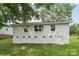 Back of a white brick house with green grass and a door at 330 Willow Oak Cir, Lancaster, SC 29720