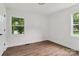 Bedroom featuring hardwood floors, fresh white paint, and double windows overlooking the side yard at 330 Willow Oak Cir, Lancaster, SC 29720