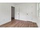 Bedroom featuring hardwood floors, fresh white paint, and double door access to another room at 330 Willow Oak Cir, Lancaster, SC 29720