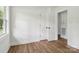 Bedroom featuring hardwood floors, fresh white paint, and double door access to another room at 330 Willow Oak Cir, Lancaster, SC 29720