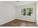 Bedroom featuring hardwood floors, fresh white paint, and a double hung window overlooking the front yard at 330 Willow Oak Cir, Lancaster, SC 29720