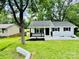Charming white ranch home featuring black trim, a cozy front porch, and a lush green lawn at 330 Willow Oak Cir, Lancaster, SC 29720