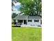 A beautifully renovated white ranch-style home with dark shutters and trim, plus a covered front porch at 330 Willow Oak Cir, Lancaster, SC 29720