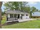 Single-story home featuring a white painted brick, black trim, and landscaped front yard at 330 Willow Oak Cir, Lancaster, SC 29720