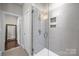 Stylish bathroom featuring a tiled walk-in shower with a niche and glass door at 336 Uptown West Dr, Charlotte, NC 28208