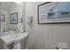 Chic powder room featuring a pedestal sink and tasteful wall art at 336 Uptown West Dr, Charlotte, NC 28208