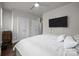 Inviting bedroom with a plush bed, mounted TV, and neutral color palette at 336 Uptown West Dr, Charlotte, NC 28208