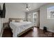 Comfortable bedroom featuring a large bed, natural lighting, and hardwood floors at 336 Uptown West Dr, Charlotte, NC 28208