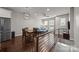 Stylish living area adjacent to a modern kitchen, featuring hardwood floors at 336 Uptown West Dr, Charlotte, NC 28208