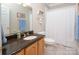 Well-lit bathroom featuring a vanity with granite countertop, tile floors, and shower with white curtain at 3504 High Ridge Rd, Charlotte, NC 29270