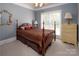 Traditional bedroom with four-poster bed, neutral carpet, large window, and matching dresser for a comfortable retreat at 3504 High Ridge Rd, Charlotte, NC 29270