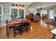 A dining area is adjacent to a living room and features wood floors and access to the exterior at 3504 High Ridge Rd, Charlotte, NC 29270