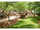 Brick home with mature trees, green lawn, and circular driveway at 3504 High Ridge Rd, Charlotte, NC 29270
