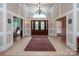 Grand foyer with tile flooring, statement chandelier, and double doors at 3504 High Ridge Rd, Charlotte, NC 29270
