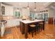 Beautiful kitchen with a large island, white cabinets, stainless steel appliances, and hardwood floors at 3504 High Ridge Rd, Charlotte, NC 29270