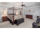 Spacious main bedroom with a four-poster bed, wood furniture, carpet and crown molding at 3504 High Ridge Rd, Charlotte, NC 29270