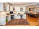 View of the office area showing the built-in desk, cabinets and wood floors. The kitchen is in the background at 3504 High Ridge Rd, Charlotte, NC 29270