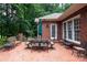 Inviting brick patio with outdoor dining set and lush greenery, ideal for relaxing and entertaining at 3504 High Ridge Rd, Charlotte, NC 29270