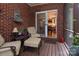 Inviting screened-in porch with brick walls, comfortable seating, and view into a charming kitchen area at 3504 High Ridge Rd, Charlotte, NC 29270