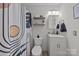 Compact bathroom featuring a modern vanity, decorative shelves, and a stylish shower curtain at 3528 Colony Rd # A, Charlotte, NC 28211