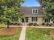 Charming brick townhouse featuring well-maintained landscaping and inviting entrance, creating a welcoming curb appeal at 3528 Colony Rd # A, Charlotte, NC 28211