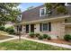 Charming brick townhouse featuring well-maintained landscaping and inviting entrance, creating a welcoming curb appeal at 3528 Colony Rd # A, Charlotte, NC 28211