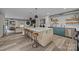 Spacious kitchen island with seating, modern appliances, and adjacent living area at 3528 Colony Rd # A, Charlotte, NC 28211