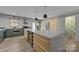 Large kitchen island with wine storage, stainless appliances, and ample countertop space at 3528 Colony Rd # A, Charlotte, NC 28211