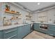 Bright kitchen featuring subway tile backsplash, open shelving, and modern blue cabinetry at 3528 Colony Rd # A, Charlotte, NC 28211
