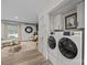 Bright laundry area featuring front loading machines adjacent to an open living space with ample natural light at 3528 Colony Rd # A, Charlotte, NC 28211