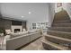 Inviting living room showcasing a fireplace, stairs with decorative tile risers, and open kitchen layout at 3528 Colony Rd # A, Charlotte, NC 28211