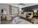 Comfortable main bedroom with a unique accent wall, plush bedding, and a bright window at 3528 Colony Rd # A, Charlotte, NC 28211