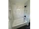 Bathroom featuring marbled tiled tub, a shower and a modern black shower head at 3700 Denson Pl, Charlotte, NC 28215